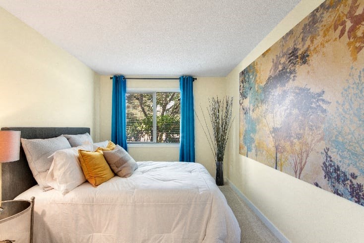 A bedroom with a large bed and a painting on the wall. at The Retreat, Sumner, WA, 98390