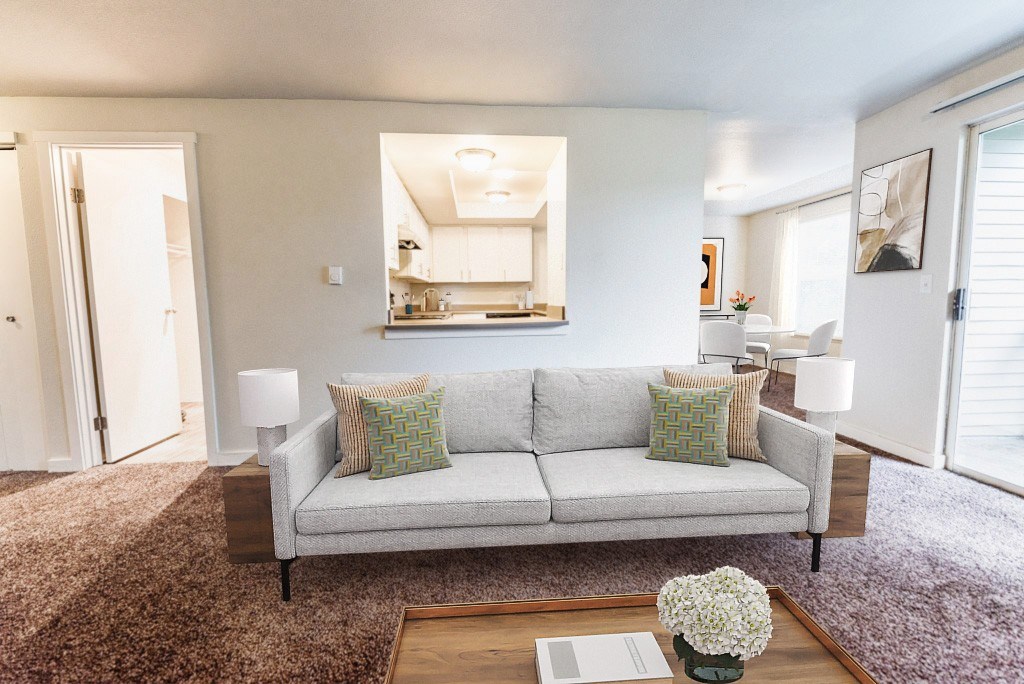 A living room with a grey couch and a coffee table.