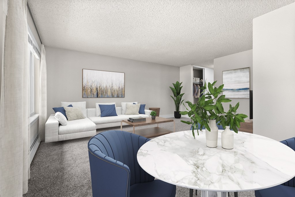 A living room with a white couch, blue chairs, and a marble table.