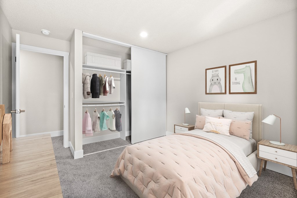 A bedroom with a large bed, a nightstand, and a wardrobe.