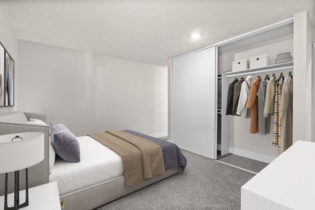 A bedroom with a bed, a wardrobe, and a table.