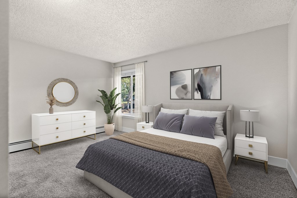 A bedroom with a bed, nightstand, and a plant.