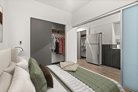 A bedroom with a bed and a wardrobe.