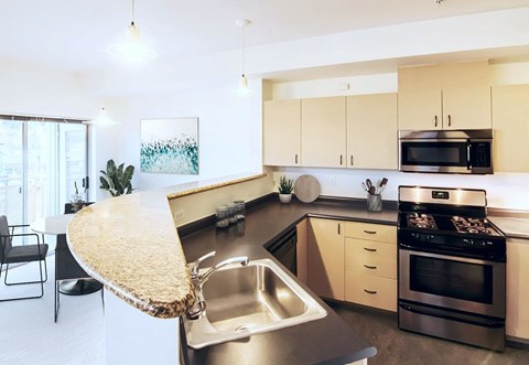 A modern kitchen with a stainless steel sink and a large island.