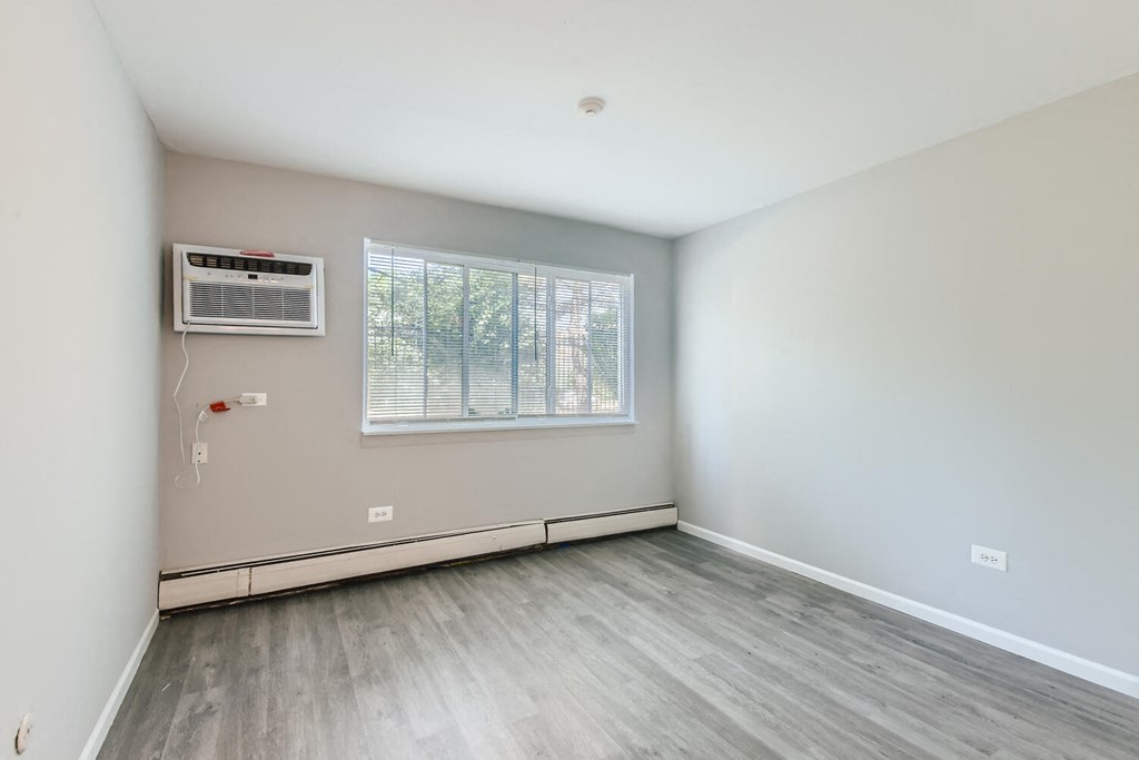 an empty room with white walls and a window