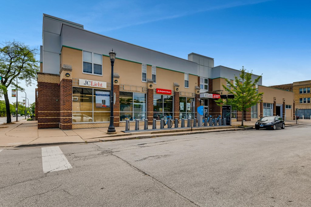 a building with a car parked outside of it on a street