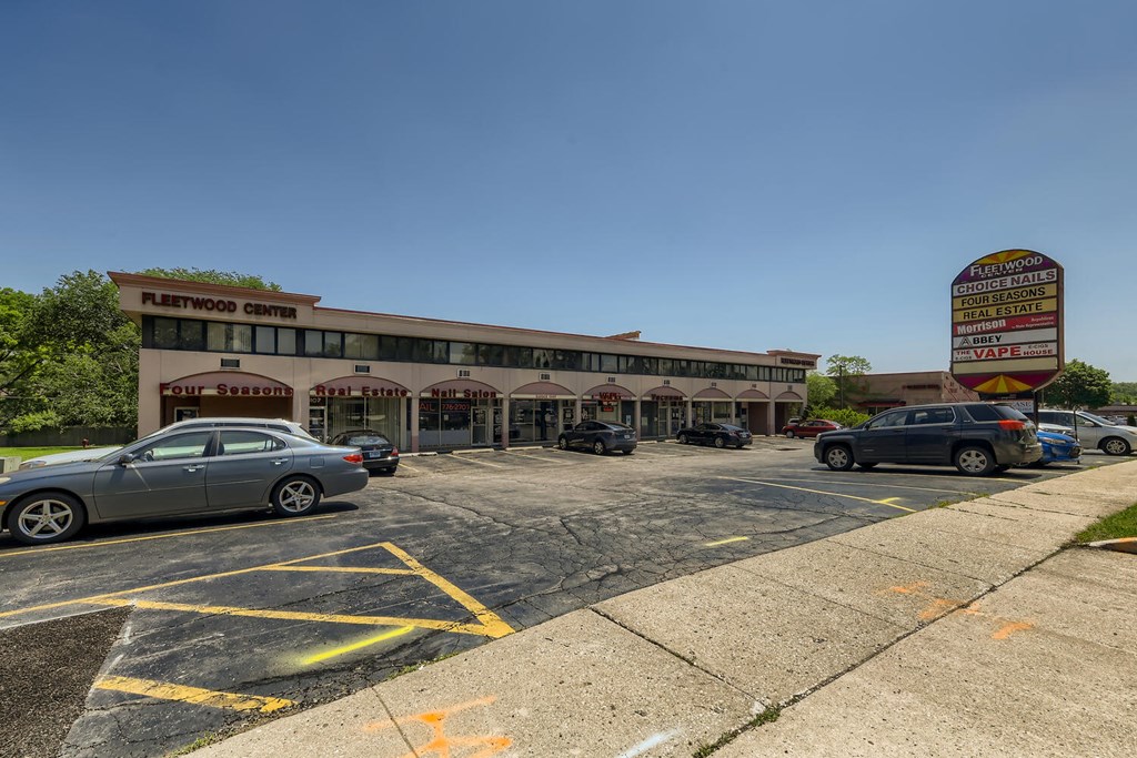 a parking lot with cars parked in front of a building