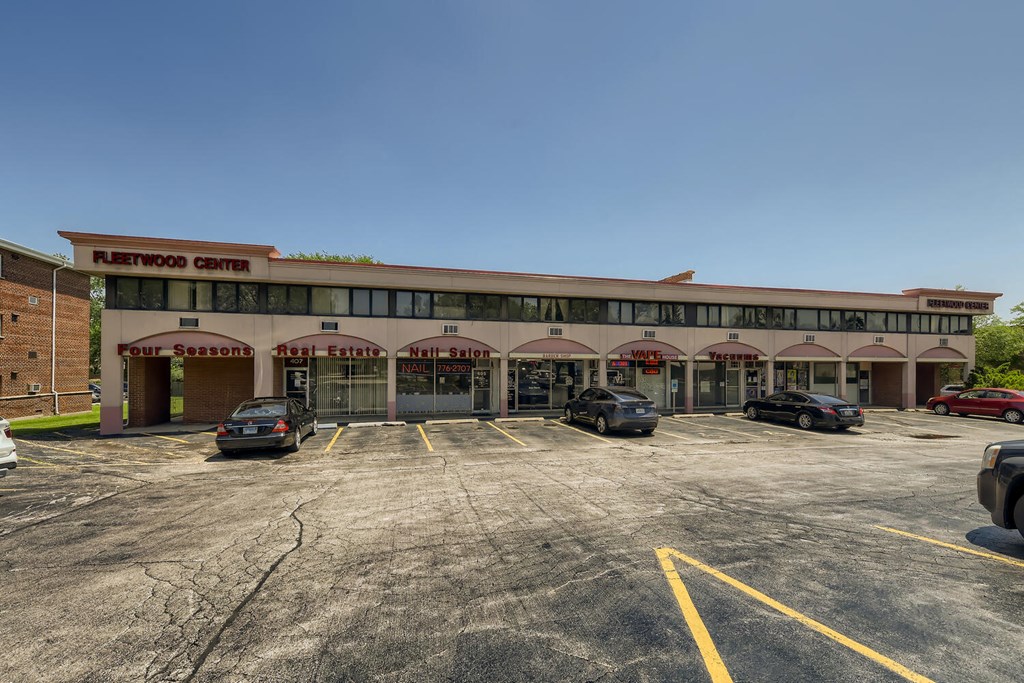 a parking lot in front of a building with cars parked