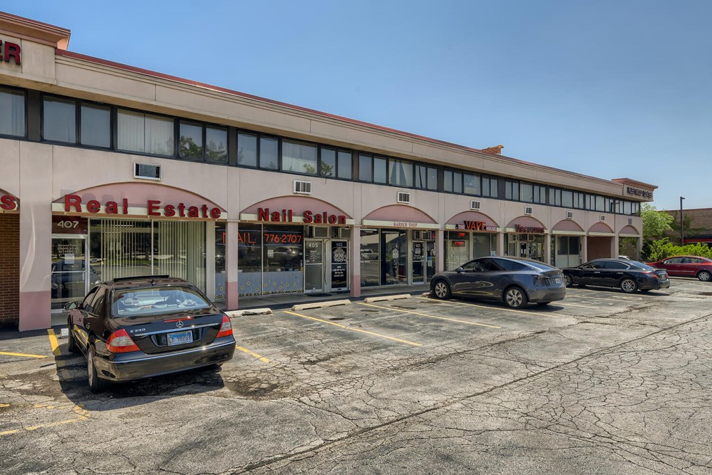 a parking lot in front of a shopping center with cars parked