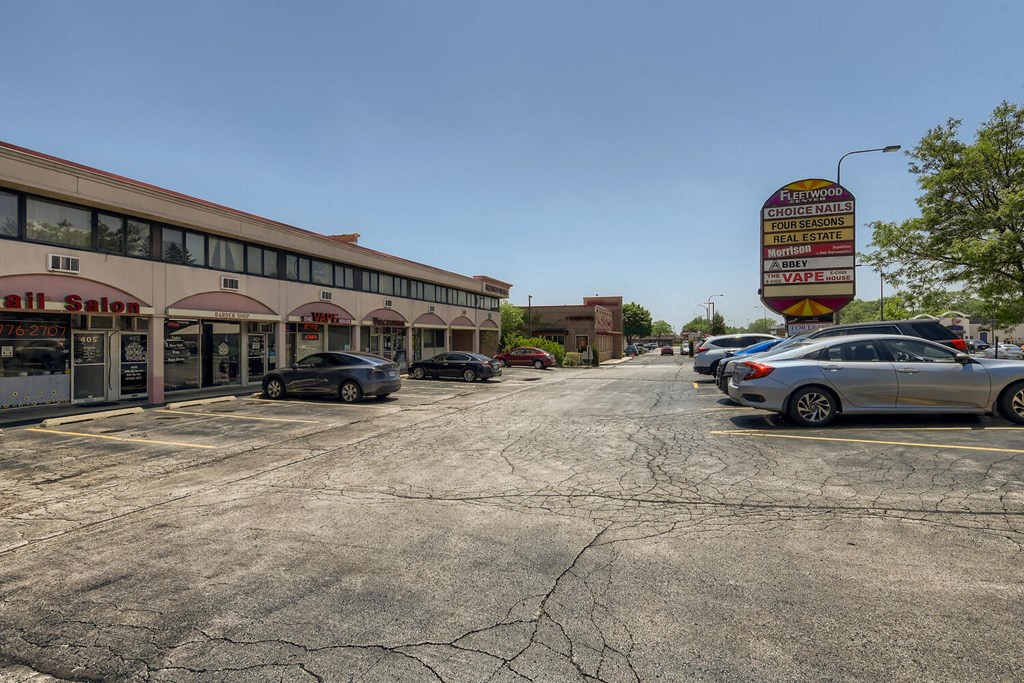 a parking lot with cars parked in front of a gas station