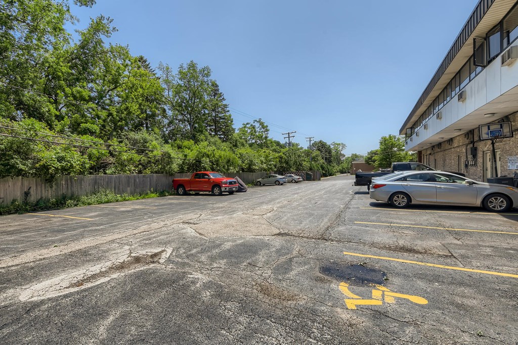 a parking lot with cars parked in front of a building