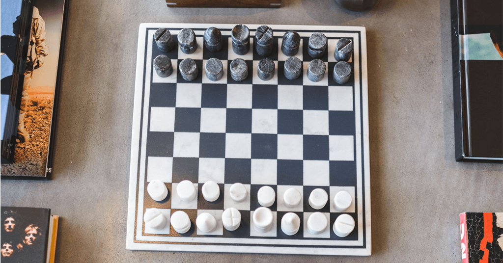 a chess board with black and white chess pieces on it