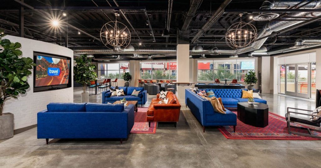 the lobby of a building with couches and chairs