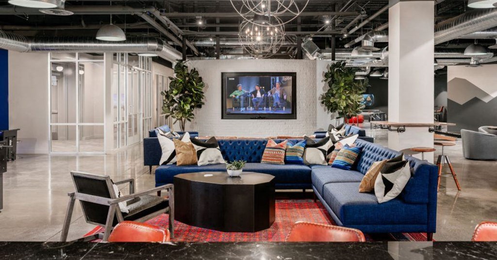 a living room with a blue couch and a tv