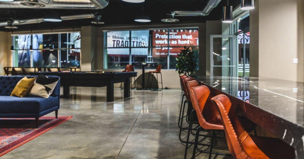 a large lobby with a pool table and chairs