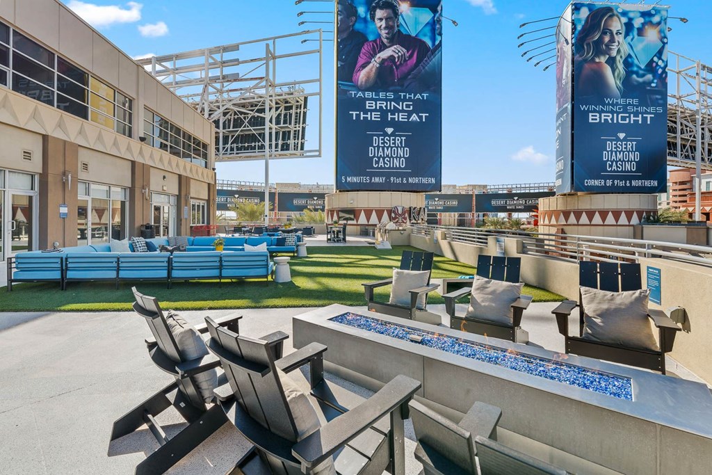 A large outdoor seating area with a pool and two large banners advertising the Desert Diamond Casino.
