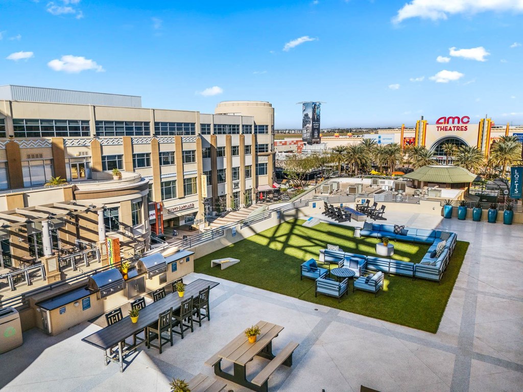 AMC Theatres is a large, modern building with a spacious outdoor seating area.