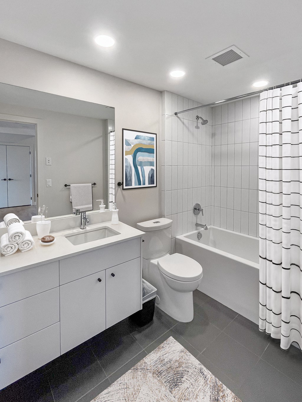 a white bathroom with a tub sink and toilet