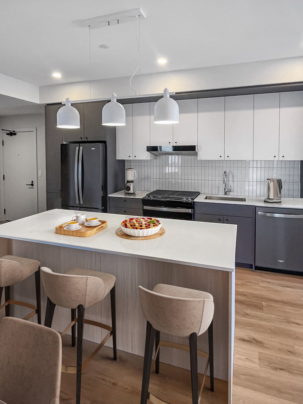 a kitchen with a large island with a pizza on it