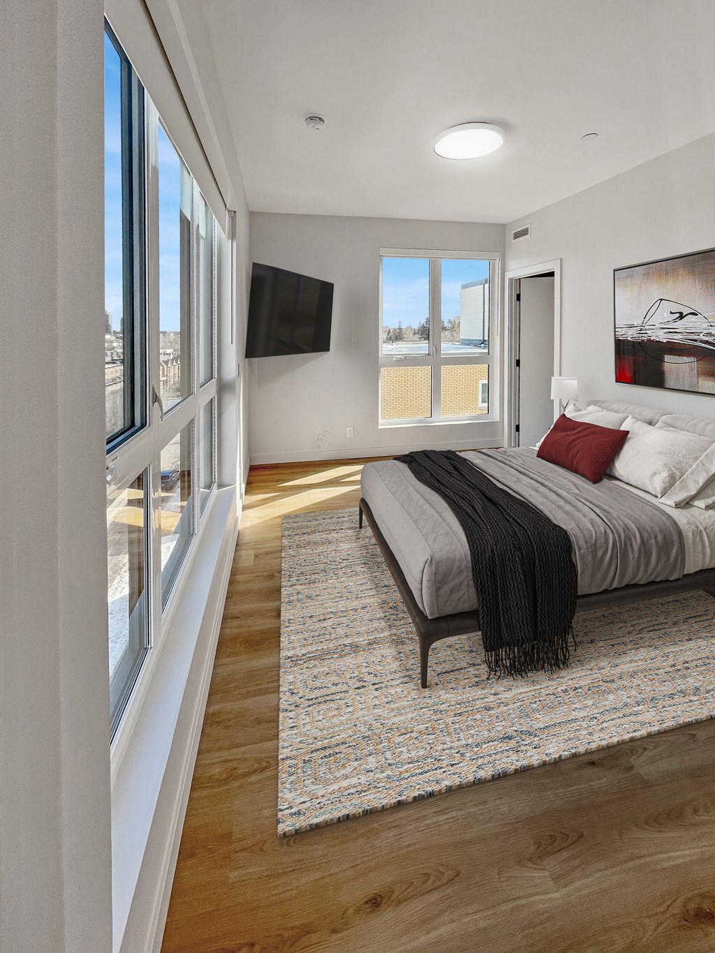 a bedroom with a bed and a large window