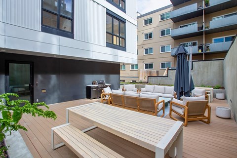 A wooden bench is in the middle of a wooden deck.