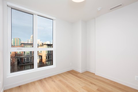 A room with a window overlooking a cityscape.