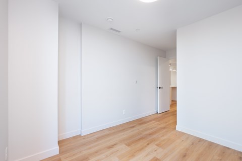 A room with white walls and wooden flooring.