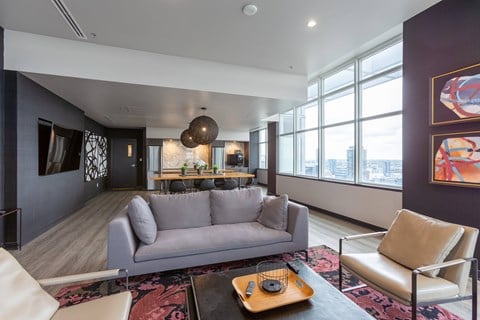 a living room with a couch and a table in front of a window