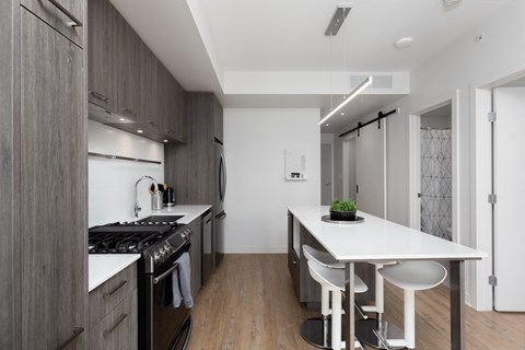 a kitchen with an island and a stove and a sink