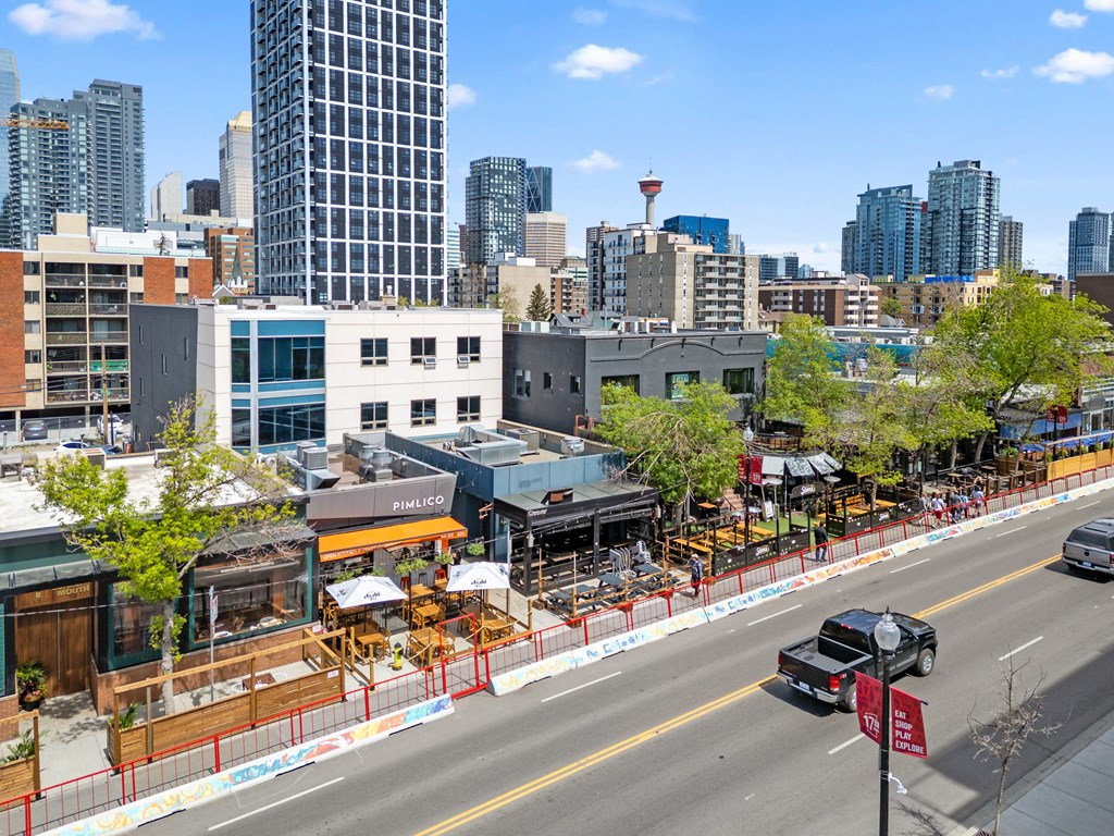 A city street with a truck parked on the side.