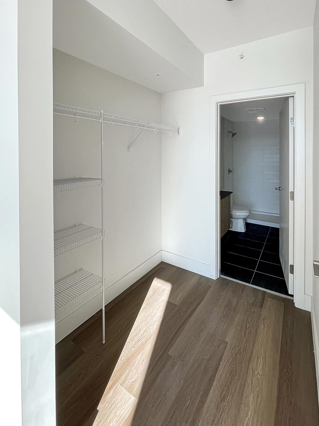 a bedroom with a closet and a door to a bathroom
