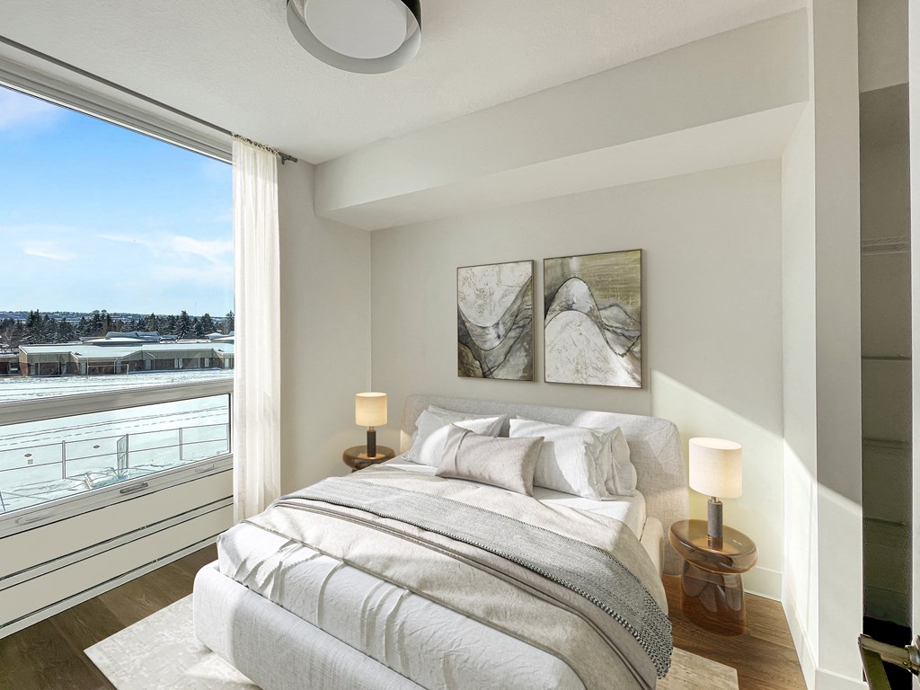 a bedroom with a bed and a large window with a view