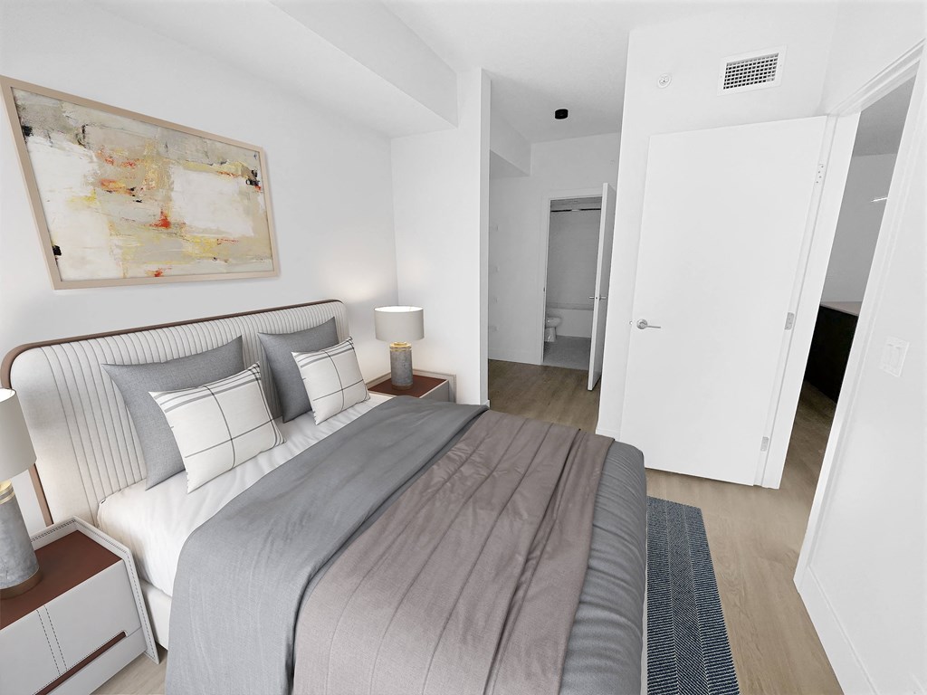 a bedroom with a large bed and a painting on the wall