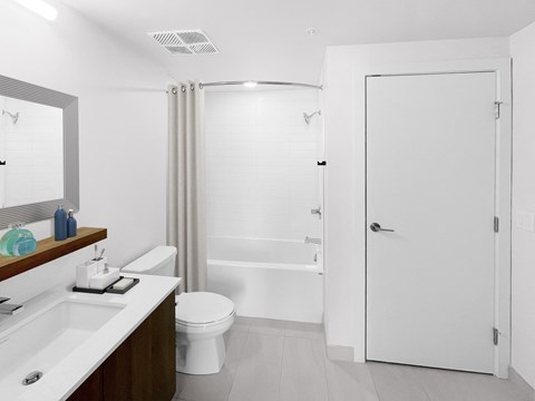a bathroom with a shower and a sink and a toilet