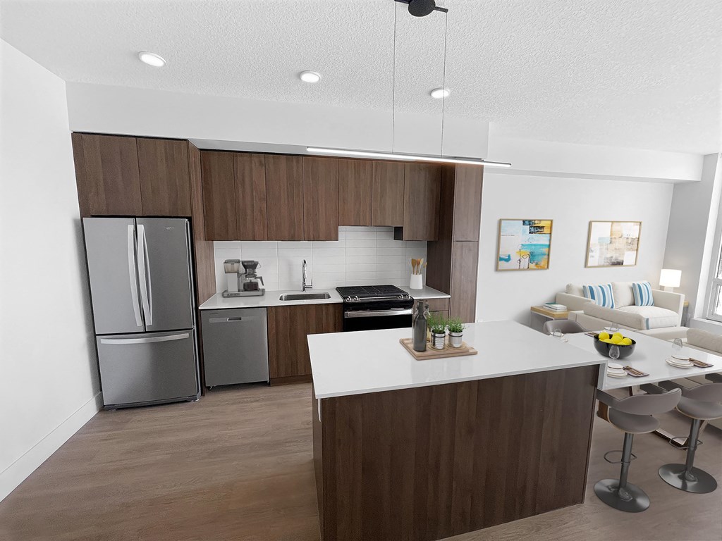 a kitchen and dining room with a stainless steel refrigerator