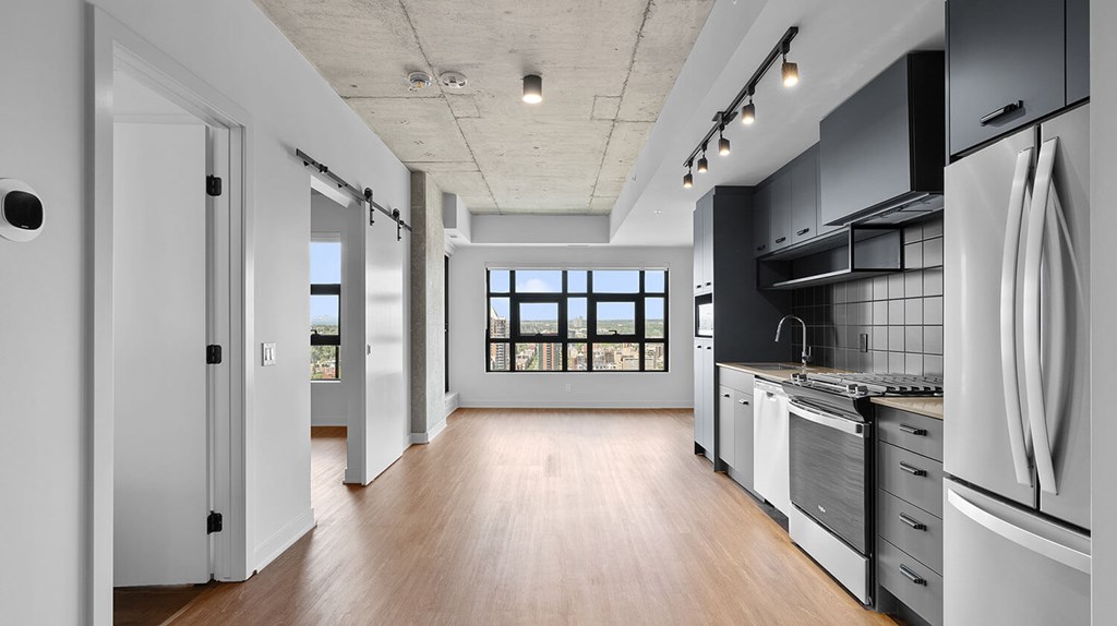 A modern kitchen with a large island and stainless steel appliances.
