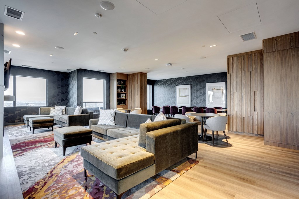 a living room with couches and chairs and a dining room with tables and chairs at Citizen on Jasper, Edmonton, T5K 0M5