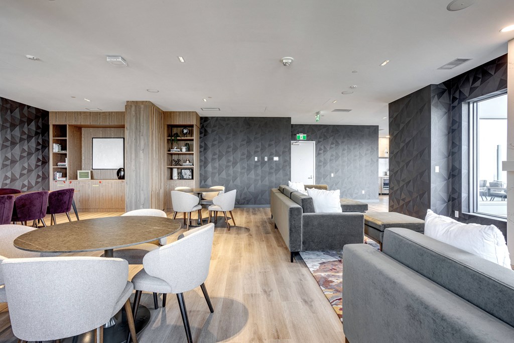 a living room with couches and tables at Citizen on Jasper, Edmonton, AB