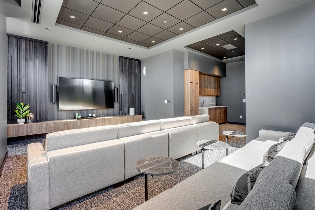 a living room filled with furniture and a flat screen tv  at Citizen on Jasper, Alberta