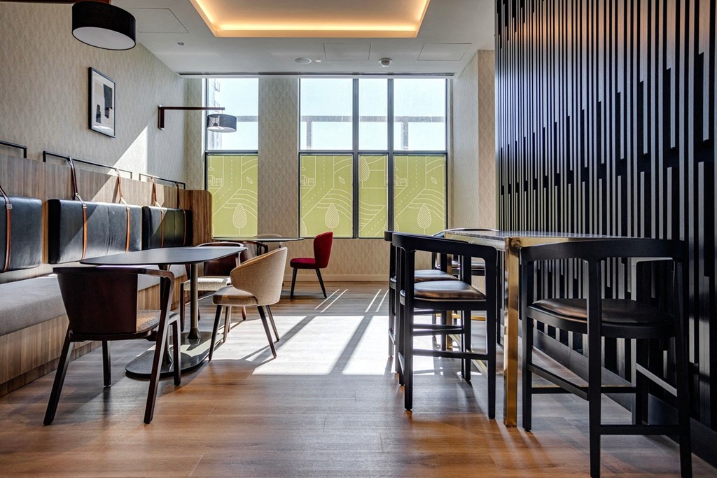 a room filled with furniture and a large window  at Citizen on Jasper, Edmonton, AB