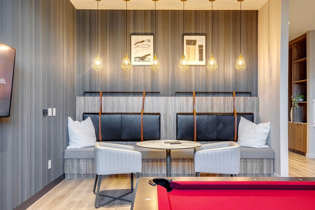 a room with a pool table and two chairs  at Citizen on Jasper, Edmonton, T5K 0M5