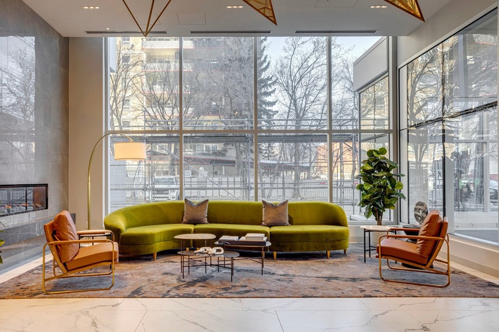 a living room filled with furniture and a large window  at Citizen on Jasper, Alberta