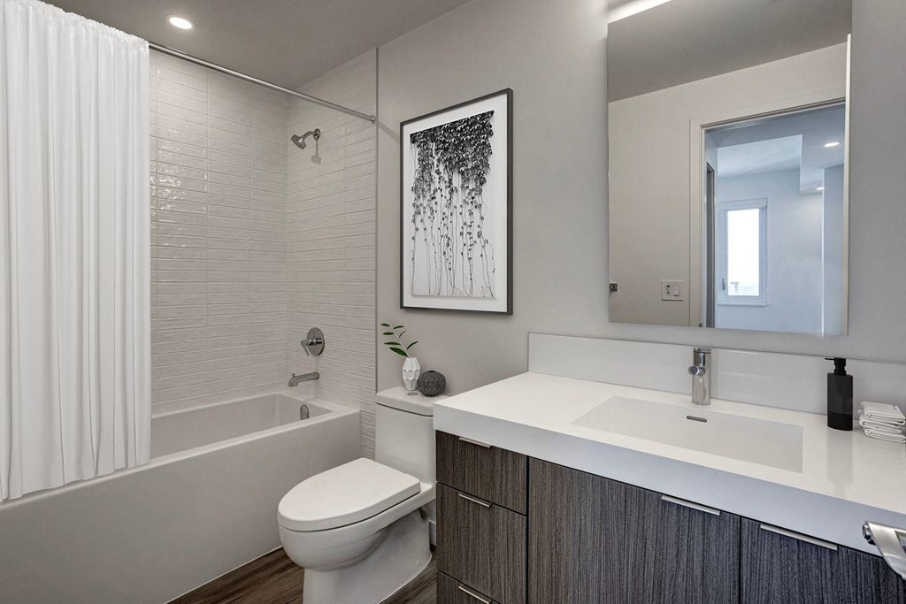 a bathroom with a toilet sink and bathtub in a 555 waverly unit  at Citizen on Jasper, Alberta, T5K 0M5