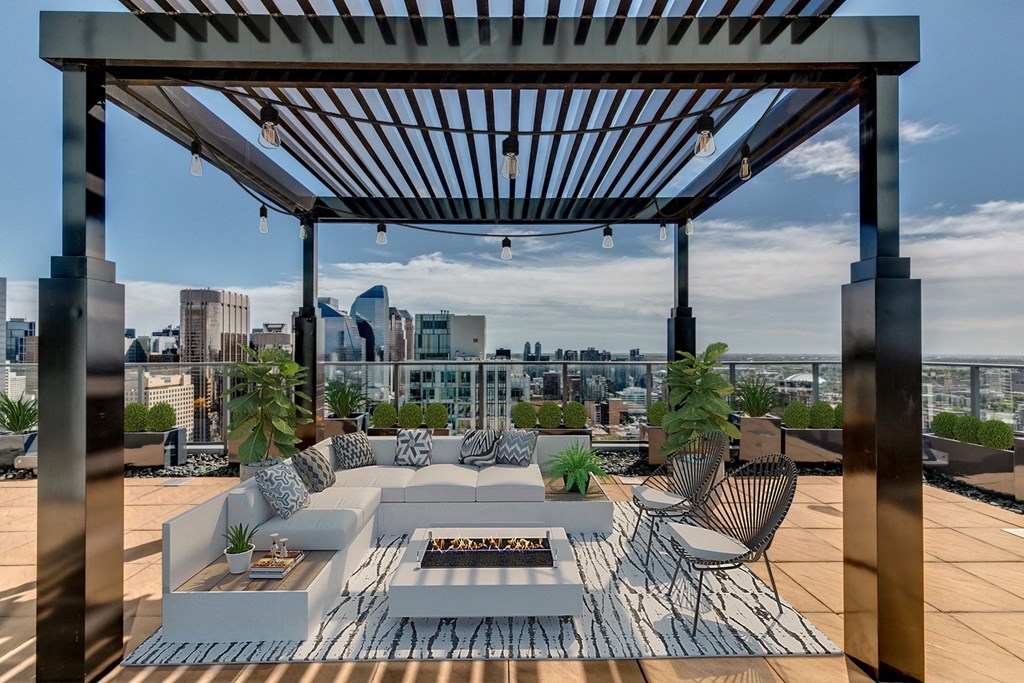 a roof terrace with furniture and a view of the city