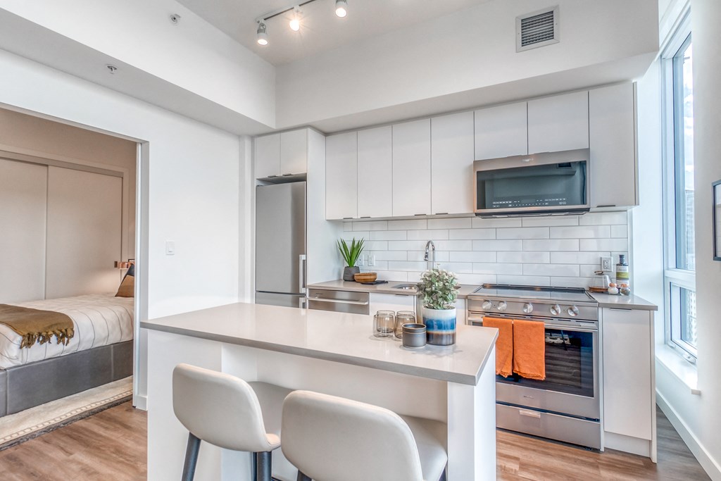 Fitted Kitchen With Island Dining at BLVD Beltline, Calgary, AB