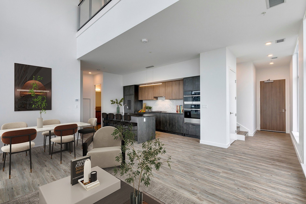 a living room with a kitchen and a dining room at BLVD Beltline, Calgary, AB