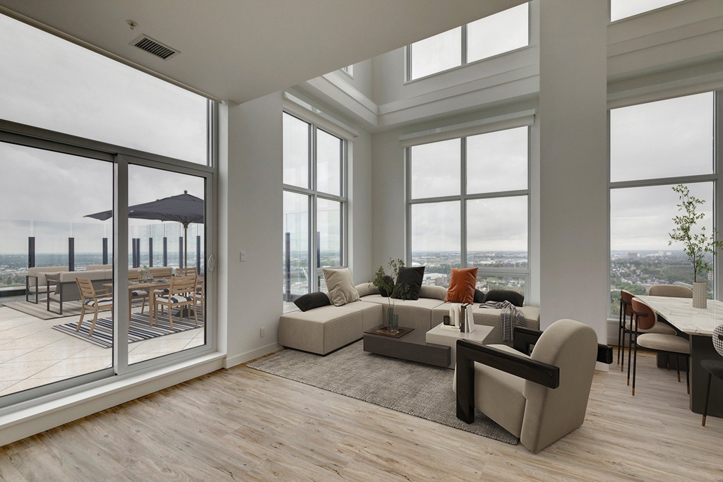 a living room with large windows and a couch and a table at BLVD Beltline, Calgary, AB