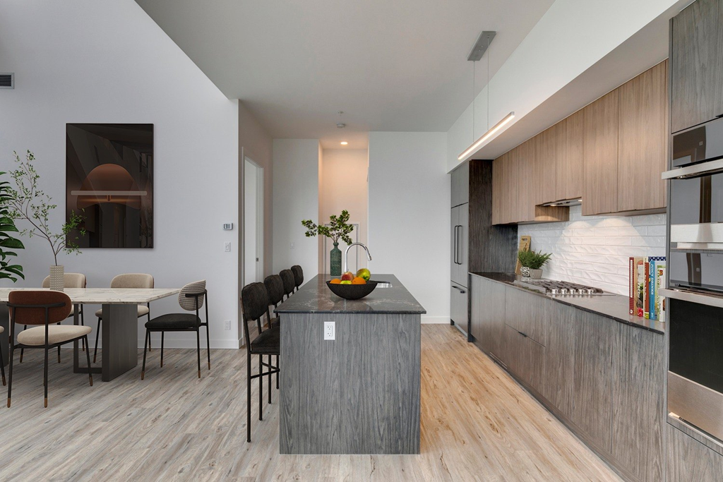 a kitchen with a large island and a dining table at BLVD Beltline, Calgary, AB