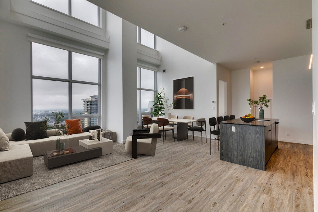 a living room with a large window and a table with chairs at BLVD Beltline, Calgary, AB