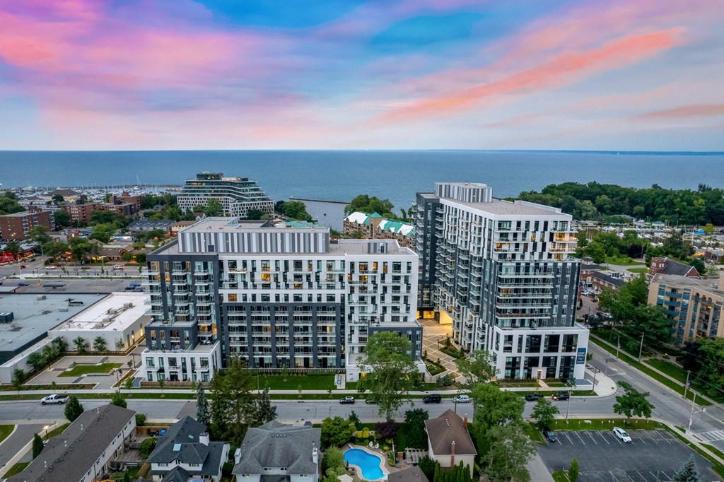 an aerial view of a city with buildings and the ocean in the background at The Village, Oakville, ON